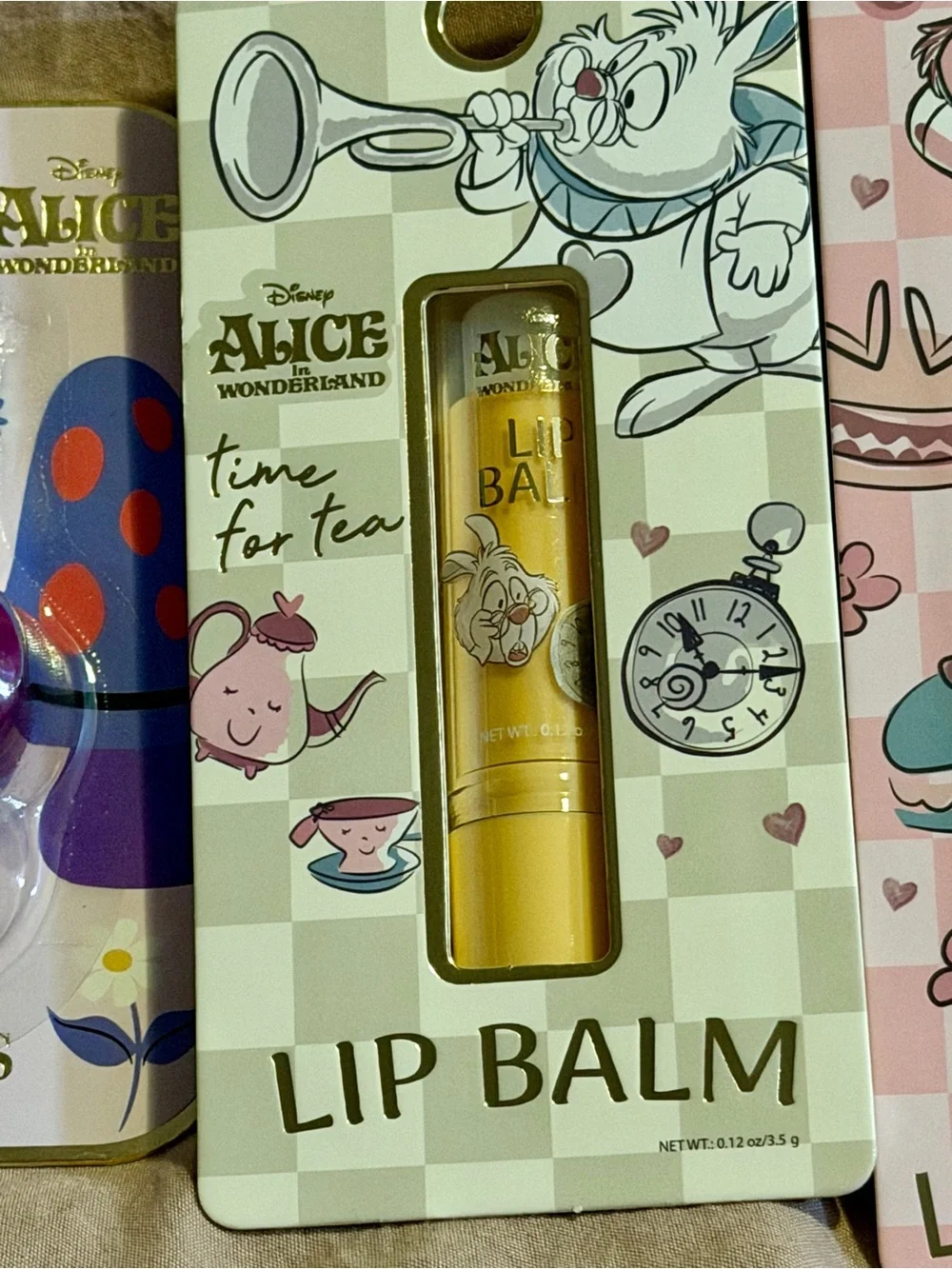 4 piece Alice in Wonderland Lip Gloss & Balm Set - Purple, Gold, Pink, Blue